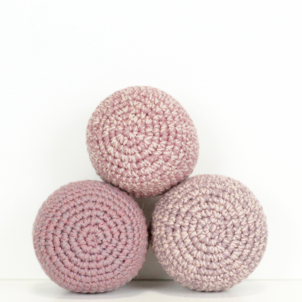 Three pink crochet balls stacked. Handmade crochet dog toys from Lana Royals Pet Wear.