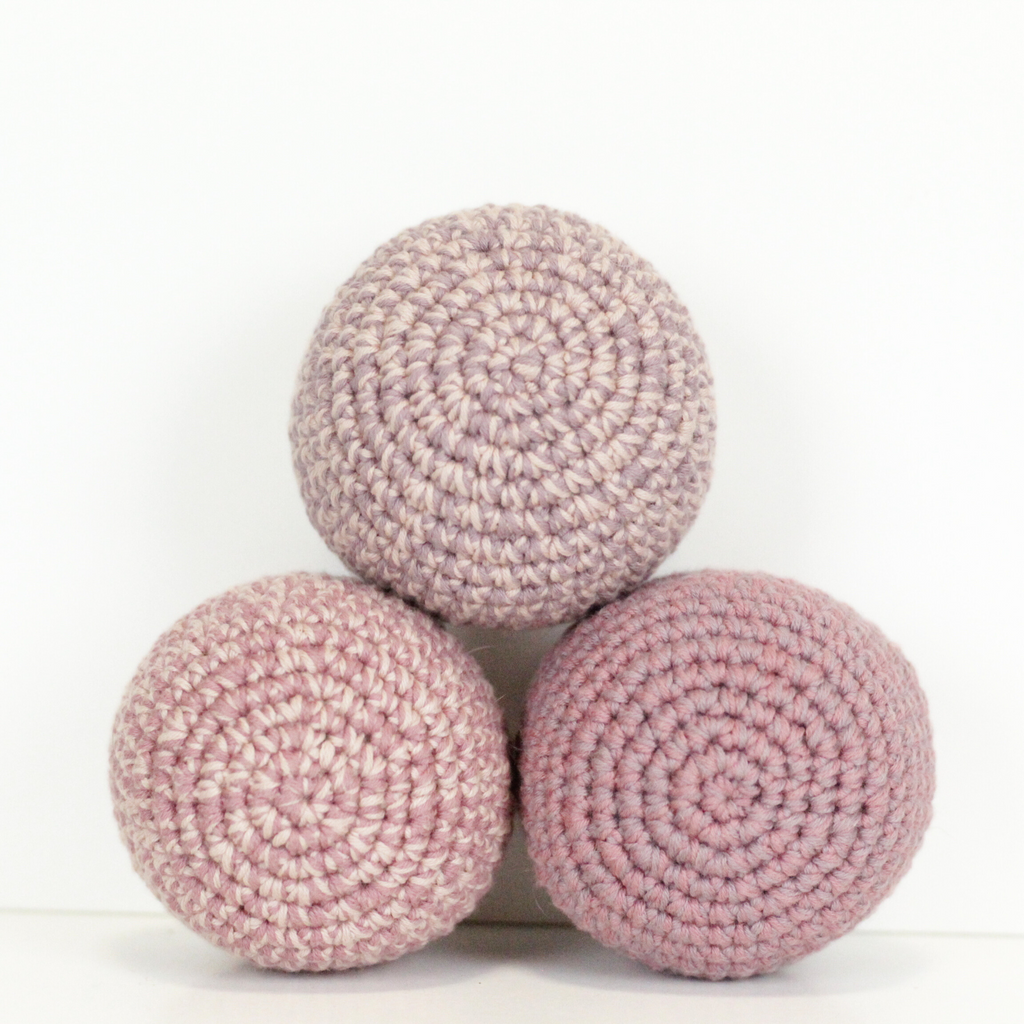 Three pink crochet balls. Handmade crochet dog toys from Lana Royals Pet Wear.