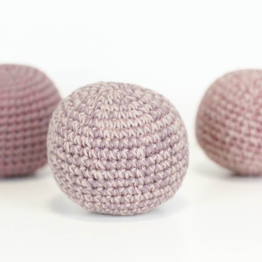 Three pink crochet balls. Handmade crochet dog toys from Lana Royals Pet Wear.