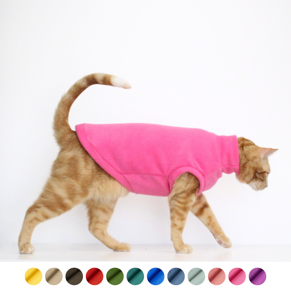 Ginger cat wearing a handmade hot pink fleece sweater vest, custom-tailored to measure by Lana Royals Pet Wear.